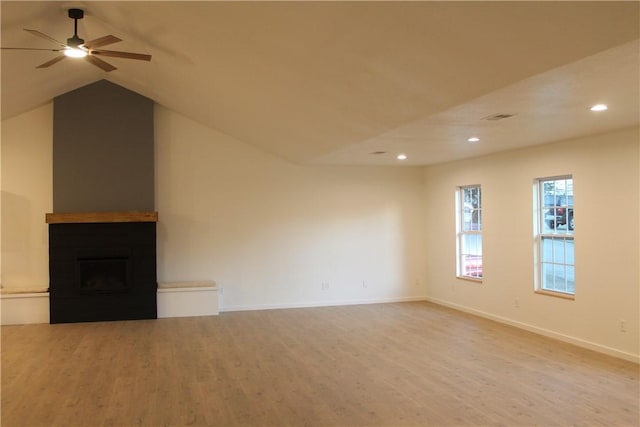 unfurnished living room with vaulted ceiling, ceiling fan, and light wood-type flooring