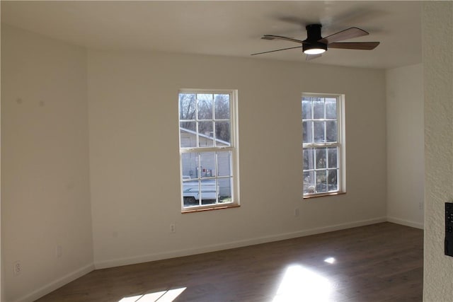 unfurnished room featuring dark hardwood / wood-style flooring and ceiling fan