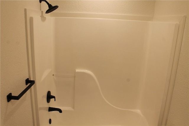 interior details with shower / bath combination