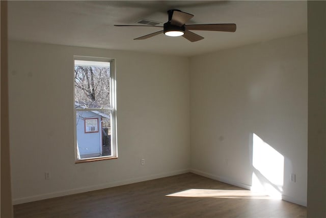 empty room with ceiling fan and hardwood / wood-style floors