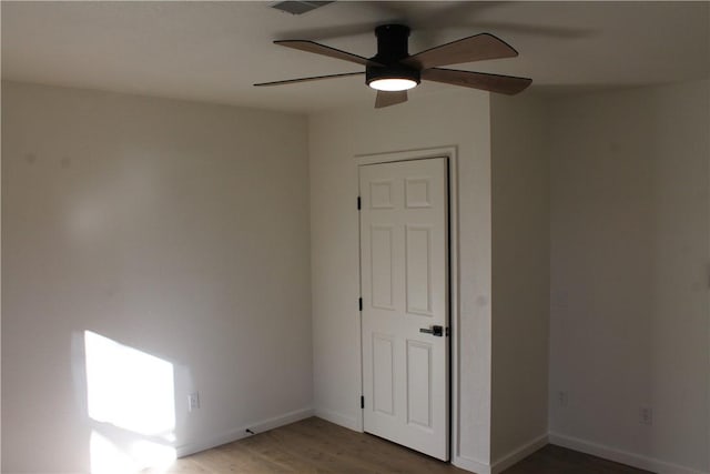 empty room featuring ceiling fan and dark hardwood / wood-style floors