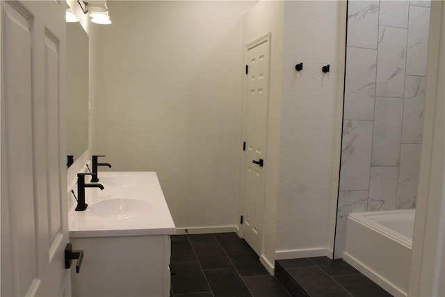 bathroom featuring vanity, a bath, and tile patterned flooring