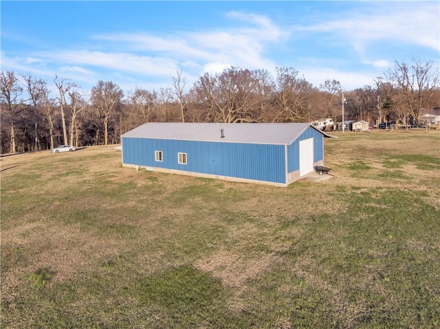 exterior space with a yard and an outbuilding