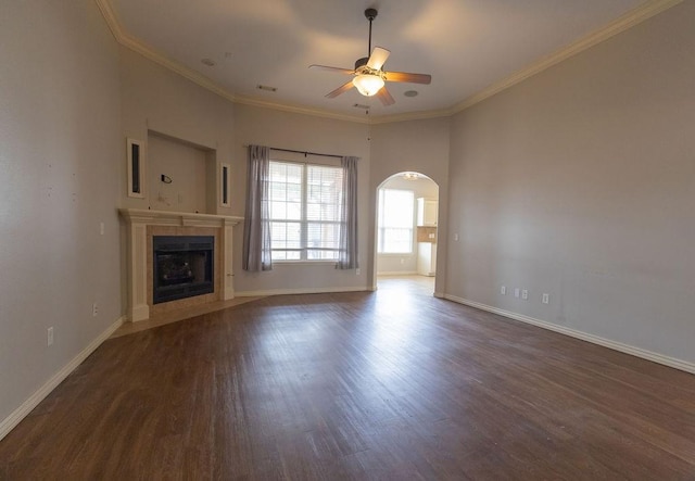 unfurnished living room with crown molding, ceiling fan, and dark hardwood / wood-style floors