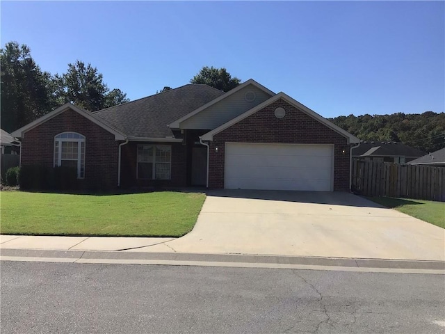 single story home featuring a garage and a front yard