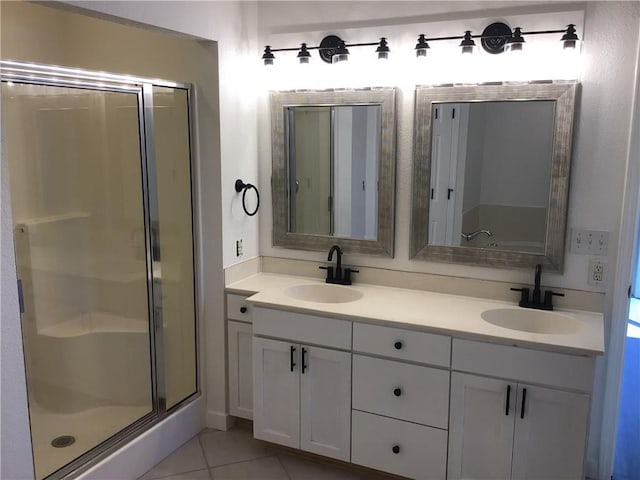 bathroom with an enclosed shower, vanity, and tile patterned flooring