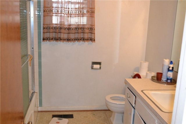 full bathroom with vanity, bath / shower combo with glass door, tile patterned floors, and toilet