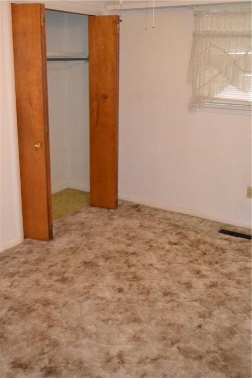 unfurnished bedroom with a closet and carpet