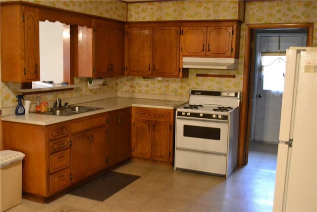 kitchen featuring white appliances and sink