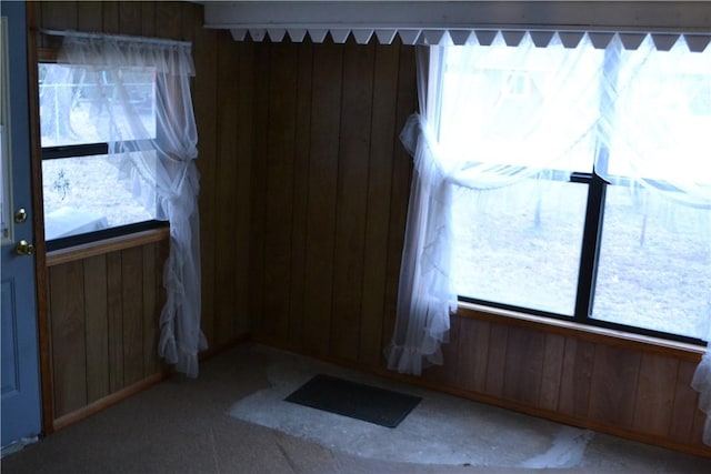 foyer featuring wood walls