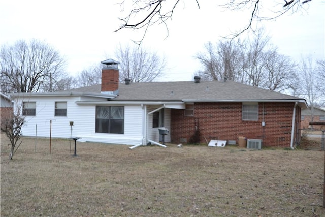 rear view of property with a lawn