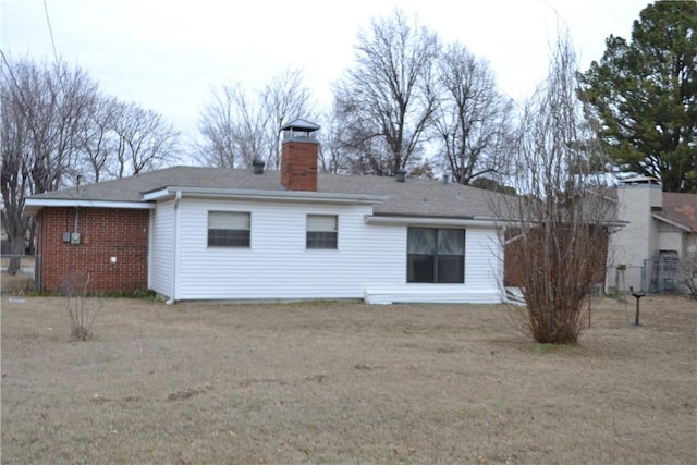 rear view of property with a lawn