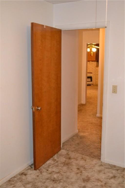 hallway featuring light carpet