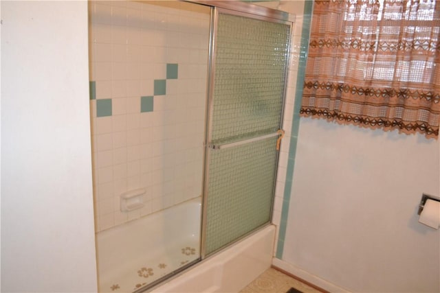 bathroom with combined bath / shower with glass door