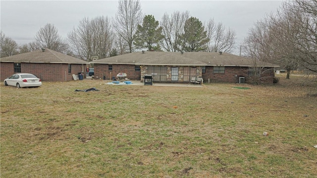 back of house featuring a yard and a patio area