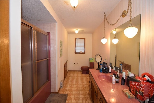 bathroom featuring vanity, toilet, and a textured ceiling