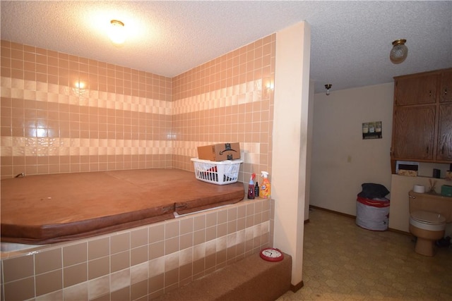 bathroom featuring toilet and a textured ceiling