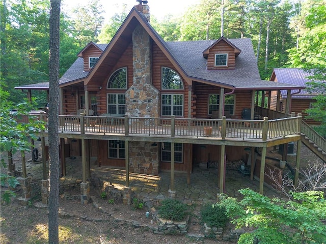 back of property with a wooden deck