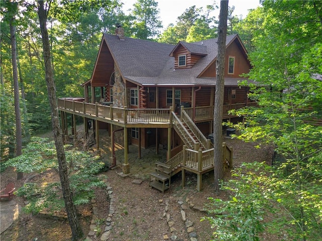 back of property featuring a wooden deck