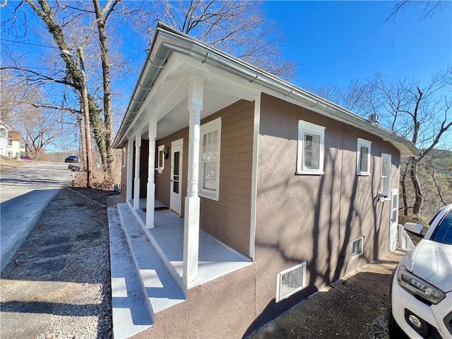 view of property exterior with covered porch