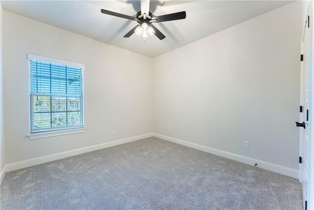 empty room with ceiling fan and carpet floors