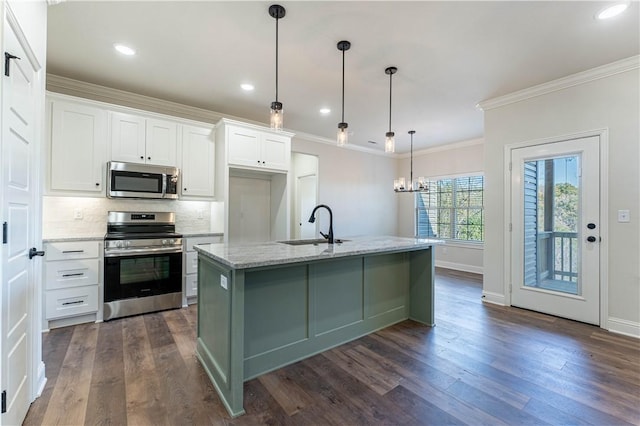 kitchen with sink, white cabinetry, stainless steel appliances, light stone countertops, and an island with sink