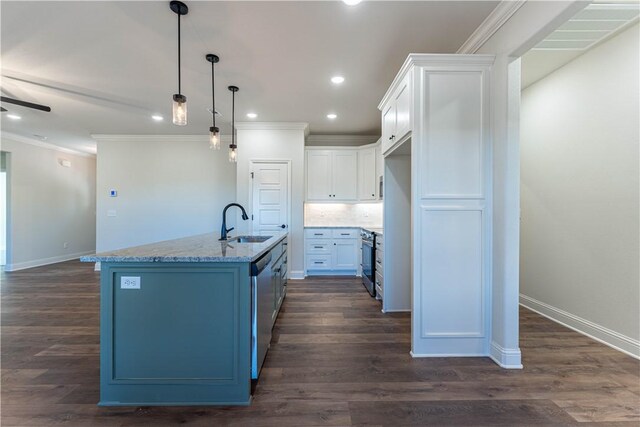 kitchen with sink, white cabinetry, hanging light fixtures, appliances with stainless steel finishes, and an island with sink