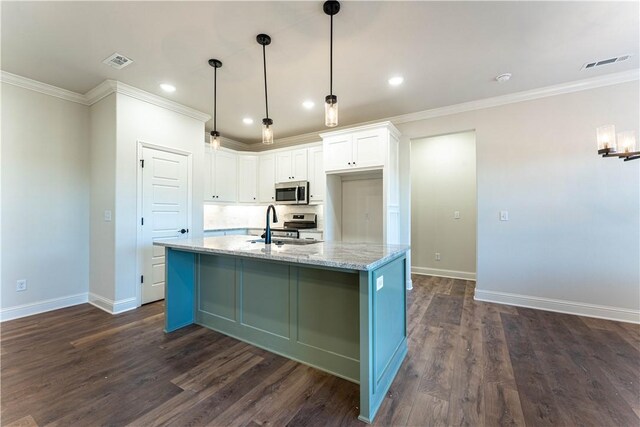 kitchen featuring pendant lighting, white cabinetry, stainless steel appliances, light stone countertops, and dark hardwood / wood-style flooring