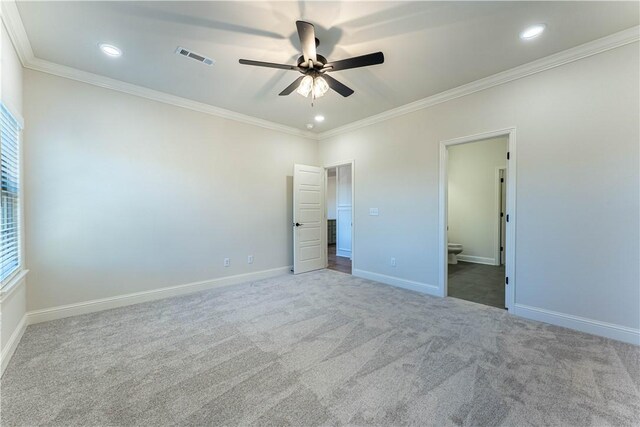 unfurnished bedroom with ornamental molding, carpet floors, connected bathroom, and ceiling fan