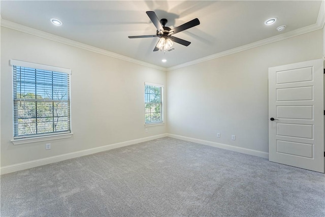 spare room with crown molding, carpet floors, and ceiling fan