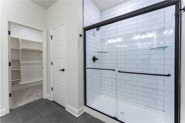 bathroom featuring tile patterned flooring and a shower with door