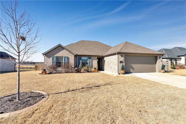 view of front of house featuring a garage and a front lawn