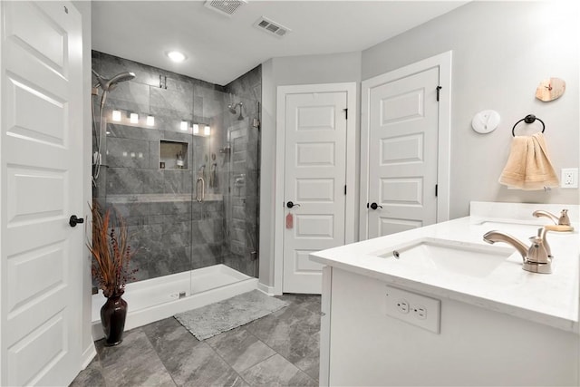 bathroom with vanity and a shower with shower door