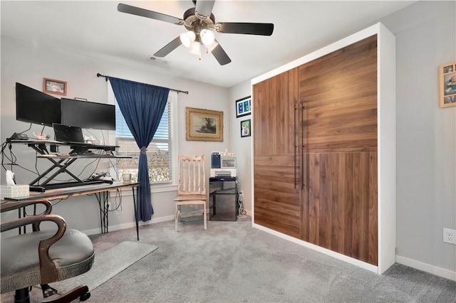 carpeted home office with ceiling fan