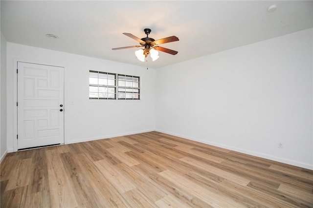 empty room with ceiling fan and light wood-type flooring