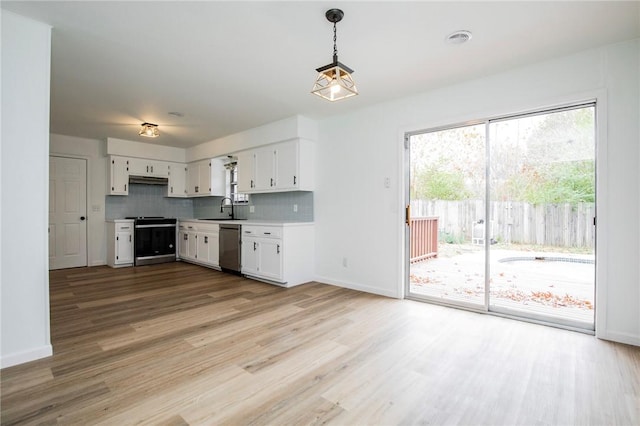 kitchen featuring sink, hanging light fixtures, white cabinets, stainless steel appliances, and backsplash