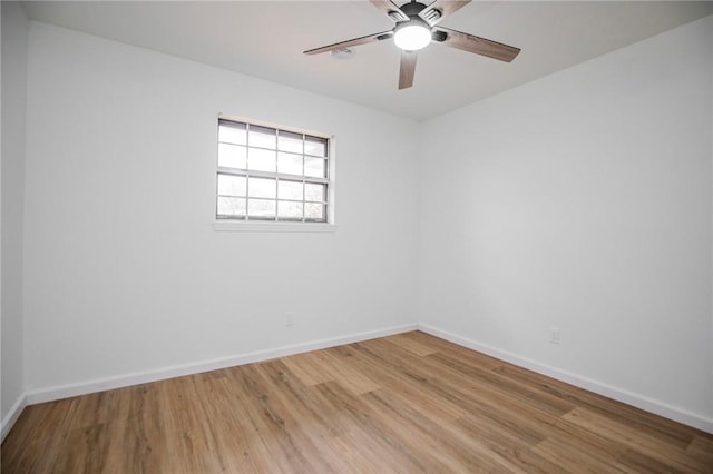 empty room featuring ceiling fan and light hardwood / wood-style flooring