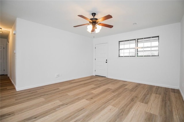 unfurnished room with ceiling fan and light wood-type flooring