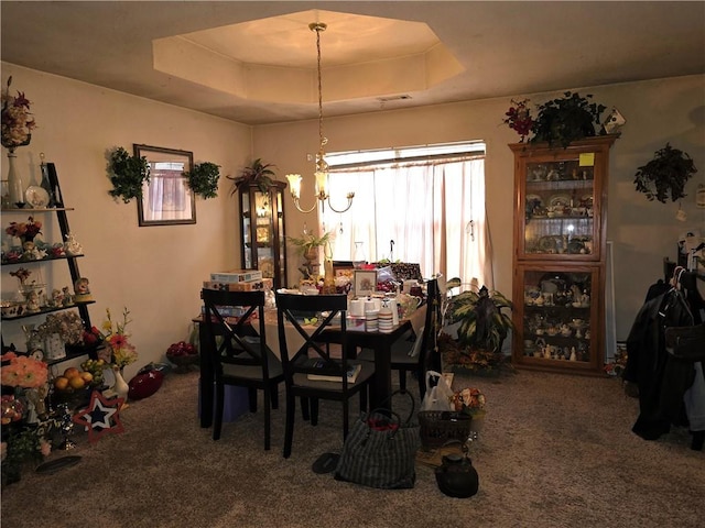 carpeted dining space featuring a raised ceiling and a notable chandelier