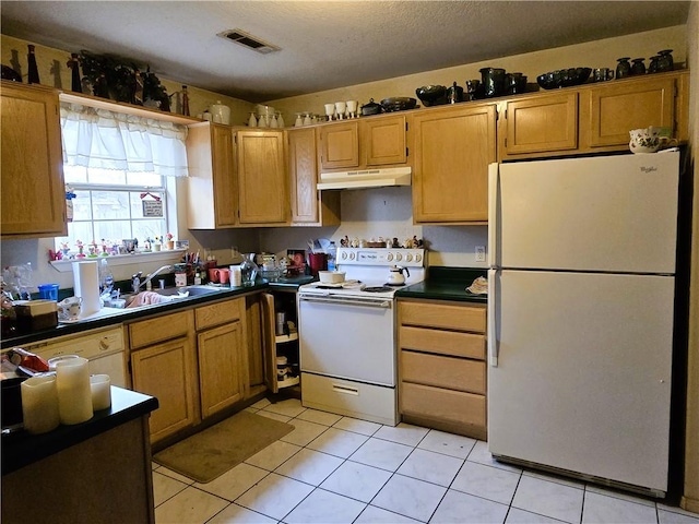 kitchen featuring light tile patterned flooring, sink, a textured ceiling, and white appliances