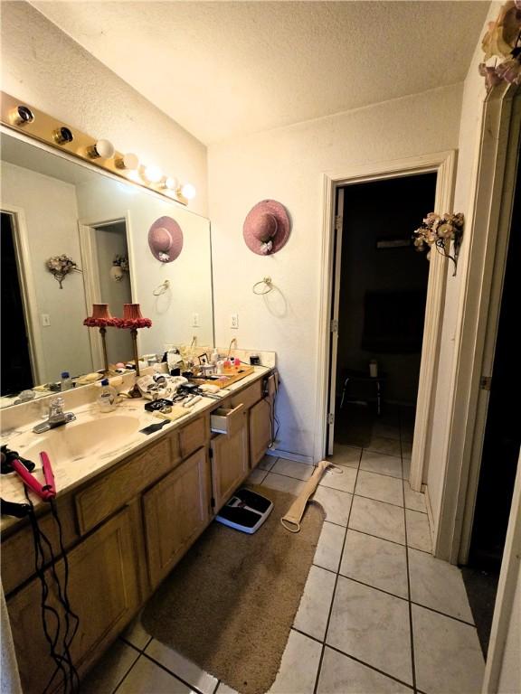 bathroom with vanity, tile patterned floors, and a textured ceiling