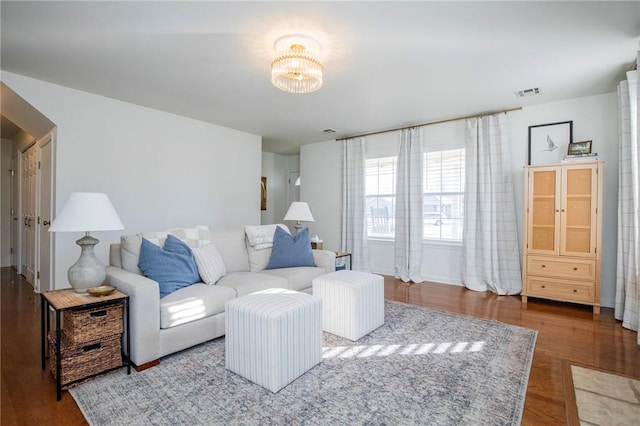 living room featuring hardwood / wood-style floors and a notable chandelier