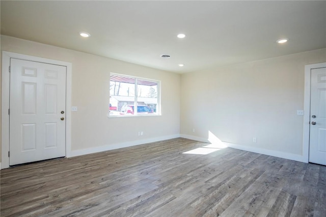 spare room with hardwood / wood-style flooring