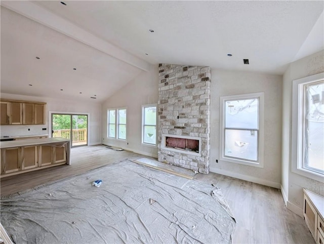 17 Burnham Dr, Bella Vista, AR 72715 - unfurnished living room with light wood-style floors, a stone fireplace, and baseboards