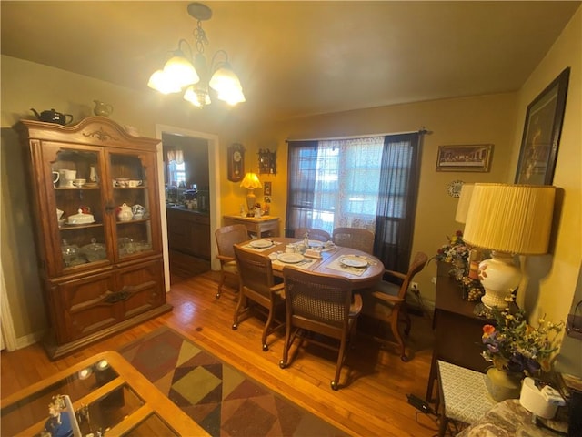 1312 S 9th St, Rogers, AR 72756 - dining space with a chandelier and wood finished floors