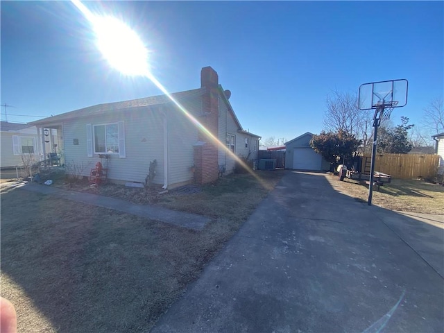 1312 S 9th St, Rogers, AR 72756 - view of front of house with an outbuilding, fence, a chimney, driveway, and a garage