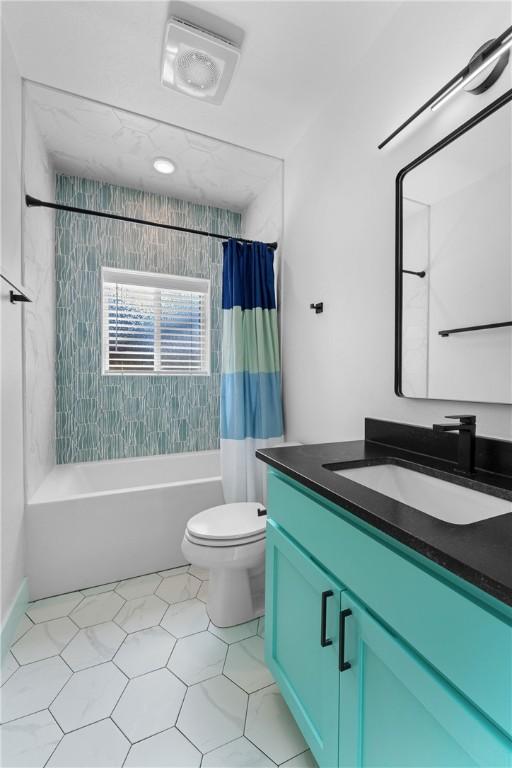 full bathroom featuring vanity, toilet, and shower / bath combo with shower curtain