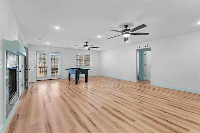 unfurnished living room featuring light hardwood / wood-style flooring, french doors, and ceiling fan