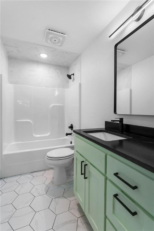 full bathroom featuring vanity, shower / washtub combination, and toilet