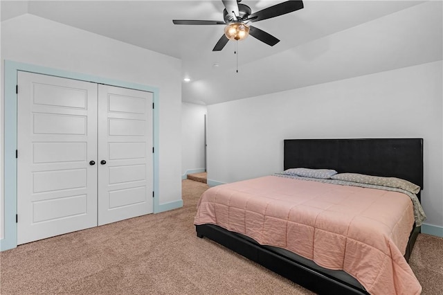 carpeted bedroom featuring lofted ceiling, ceiling fan, and a closet